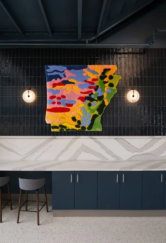 Fiber artwork in the shape of Arkansas installed above a counter at The Visionaries, curated by MIXD Gallery